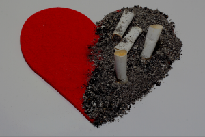 image showing half heart in red colour and half heart in cigarette ashes.