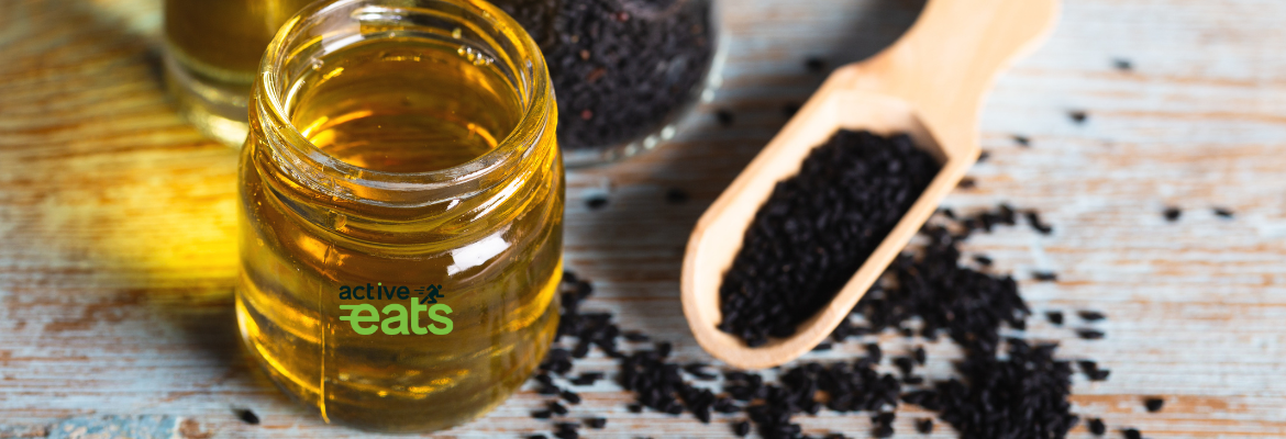 Image shows black seeds and black seed oil in a glass bottle.