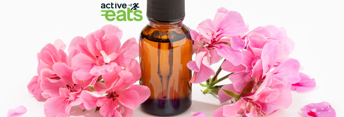 picture shows Geranium flowers and Geranium essential oil next to it in a glass bottle
