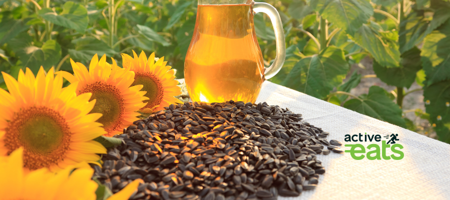 picture shows sunflower and sunflower seeds next to it along with sunflower oil in a glass bottle